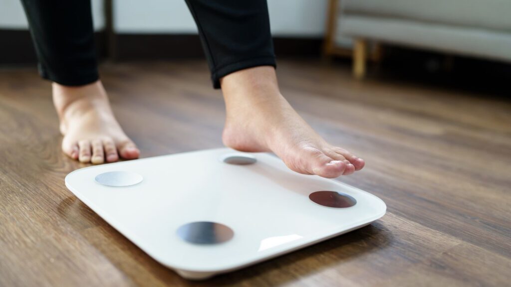 Women About To Step Onto A Weight Scale