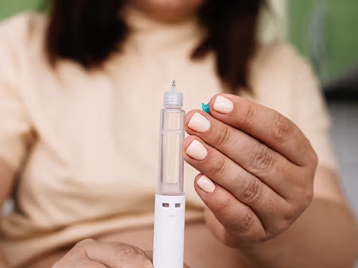 Women Holding A Wegovy Medication Injector Pen
