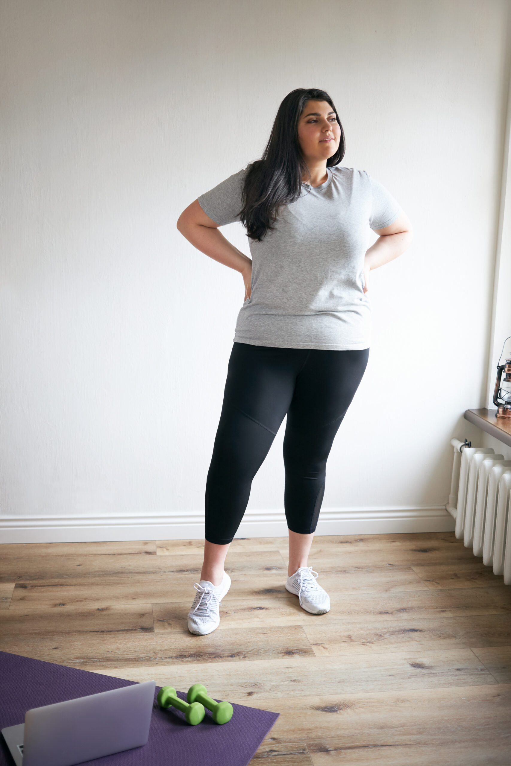 Woman Doing Workout And Standing By A Yoga Mat