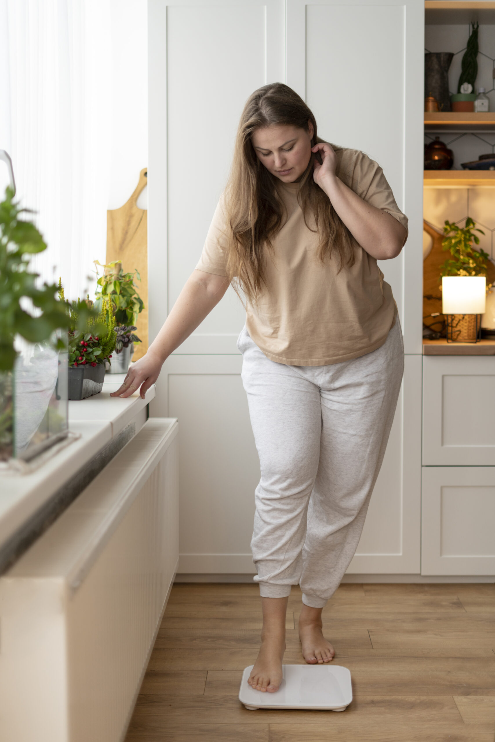 Woman Standing On A Weight Scale To Check Weight